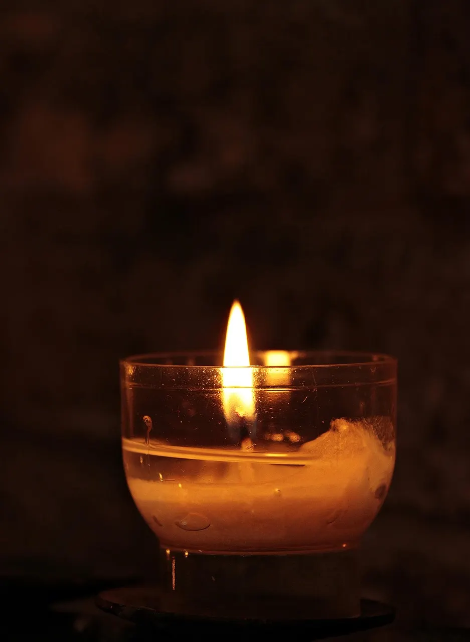 A candle glowing quietly in remembrance