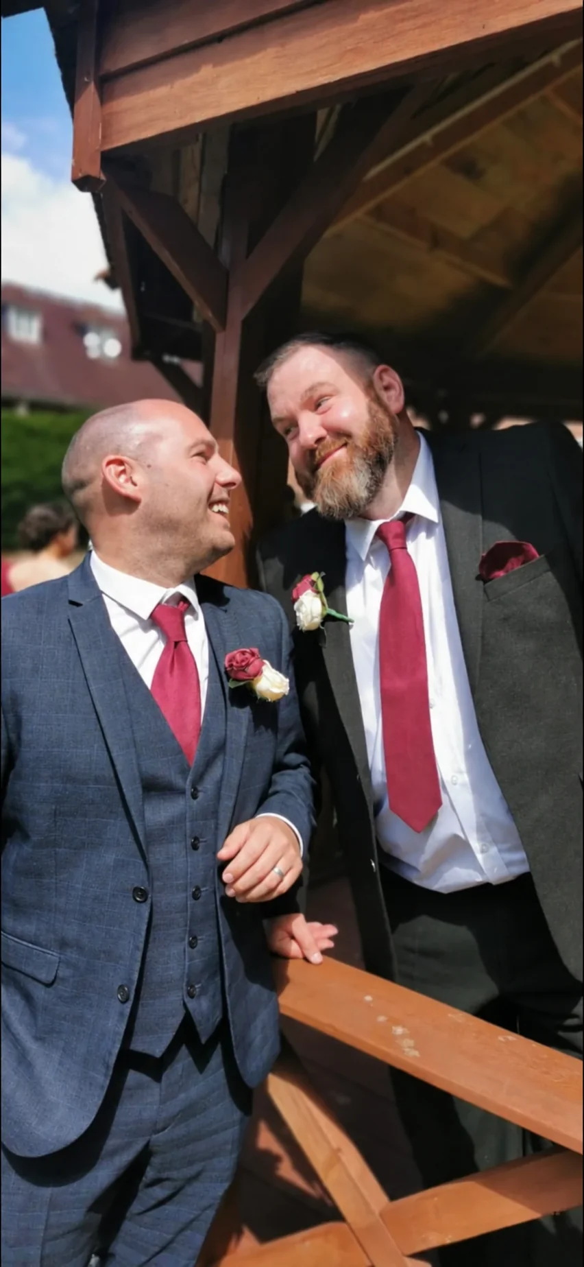 Two grooms smiling together on their wedding day